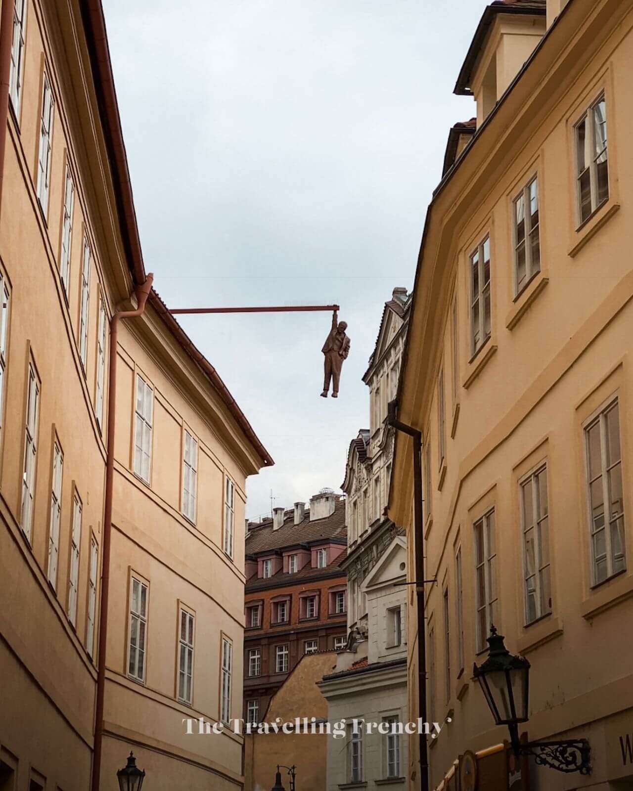 Man Hanging Out Statue in Prague