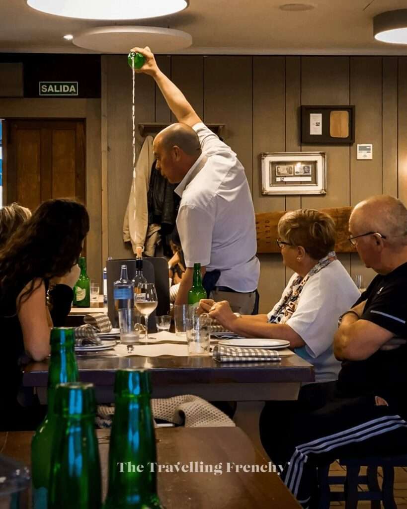 Waiter pouring cider at Restaurant Casa Trabanco in Gijon Spain